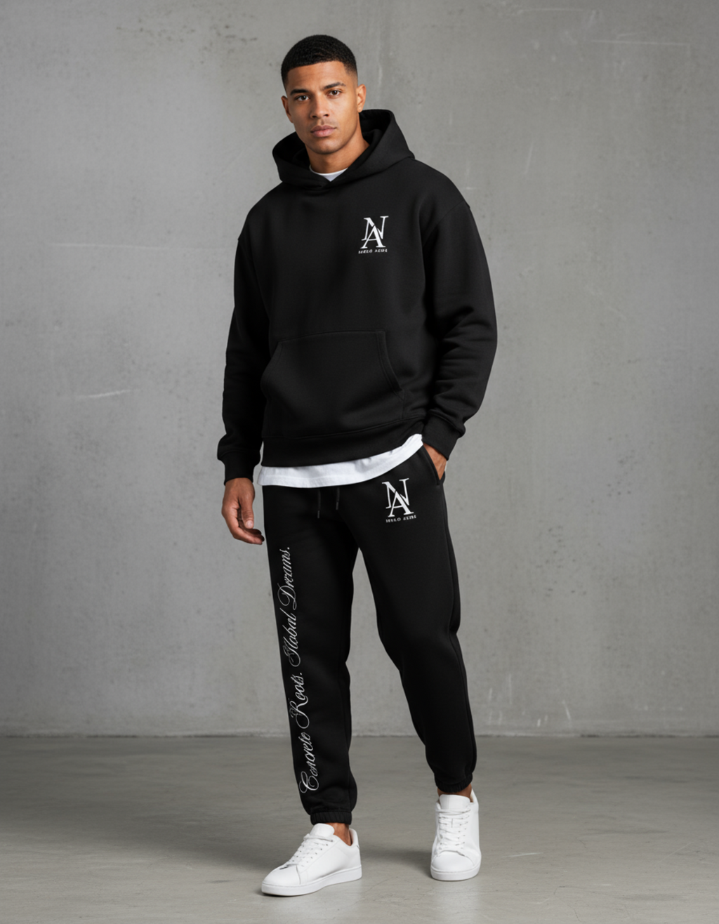 „Model trägt Niklo Auri Concrete Roots Jogger – schwarzer Heavy Jogger mit Script Print.“